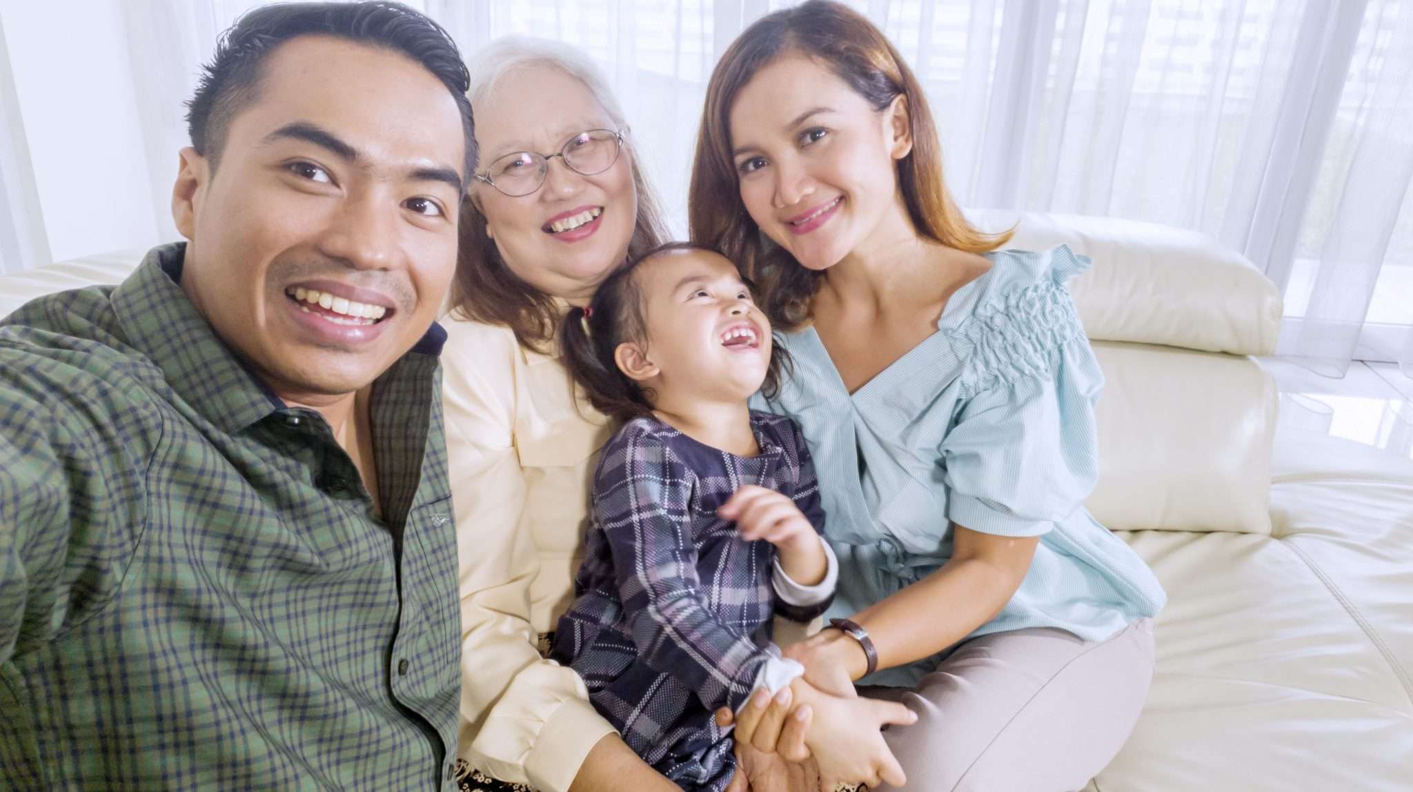 Cheerful family takes a group picture at home